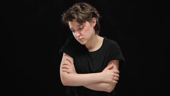 Middle Shot Portrait of Frustrated Abused Young Woman with Beaten Face and Crossed Hands Thinking