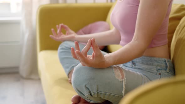 Close Up View of Hands of Unrecognizable Slender Girl Who is Doing Asana While Sitting in Lotus Pose