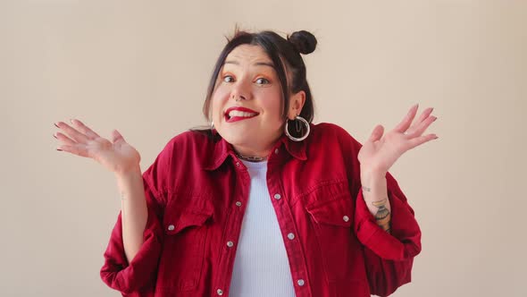 Confused trendy uncertain brunette woman shy shamed spreading hands say i am sorry, oops