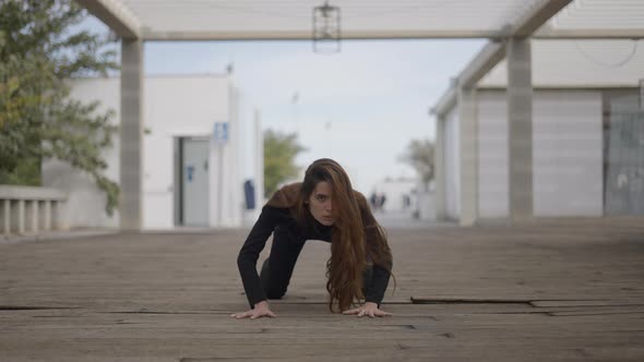 Young Woman Outdoors Moves on All Fours Like a Cat Static Ground View