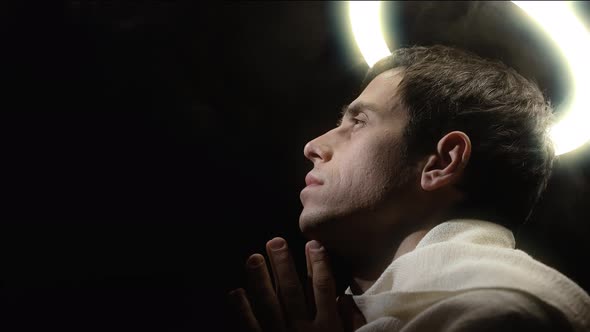 Holy Man with a Halo Praying with Folding Palms