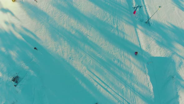 Snowy Track with Skiing People at Winter Resort Aerial View