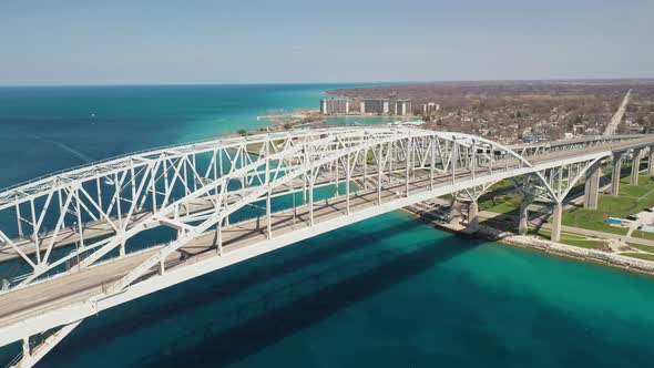 Blue Water Bridge connecting Port Huron, Michigan USA and Sarnia, Ontario Canada with droneing down.