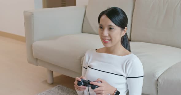 Woman play tv game at home