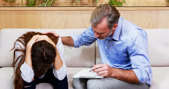 Doctor consoling female patient