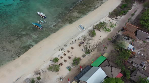 aerial top down of white sand beach bar on Gili Meno Island with turquoise water