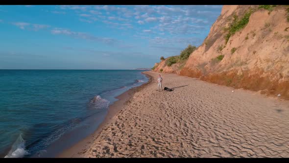 Vocalist emotionally singing on beach. Man singing song in microphone during performing concert