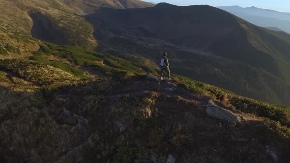 Aerial View of Hiker Man with Backpack on Top of a Mountain