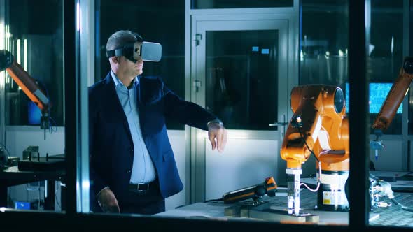 Male Researcher is Operating a Robotic Mechanism in a Virtual Reality