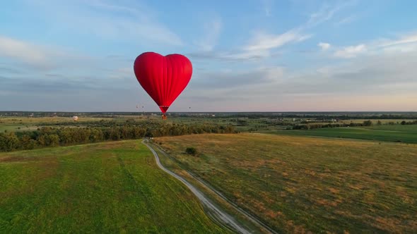 Balloon in the form of heart over fields