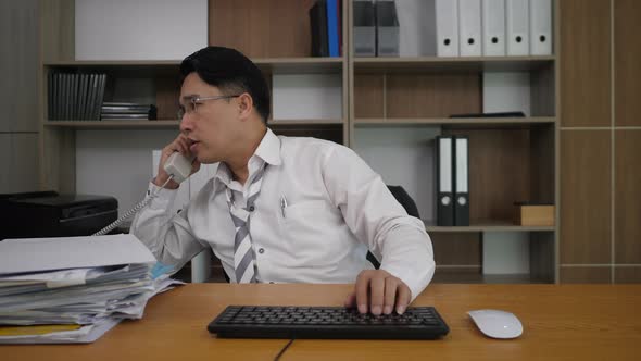 Businessman office worker typing at the laptop computer and many work