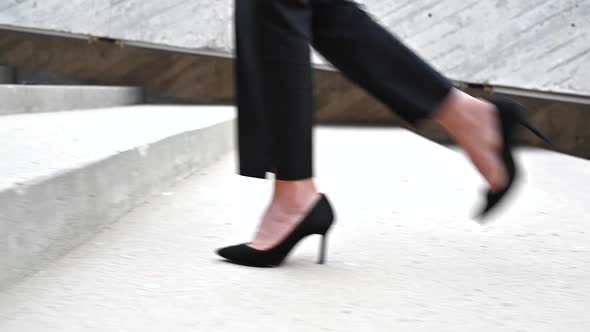 Businesswoman Wearing Heels Climbing the Stairs in the City. Slow Motion Close Up on Legs.