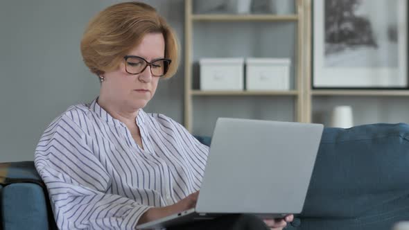 Old Woman Working On Laptop