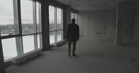 Businessman Examining Empty Lofr Space for Future Office