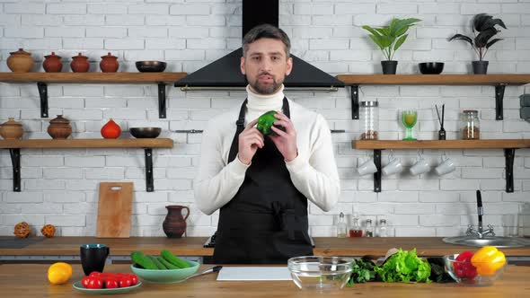 Thoughtful chef teacher listen online question video culinary webinar in kitchen