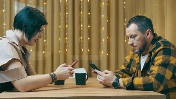 Young Couple of Modern People Spend Time Together with Mobile Phone