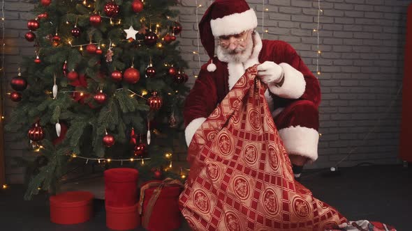 Santa Claus Leave Gifts Under the Christmas Tree