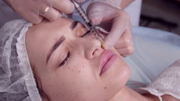 Anti Aging Concept. Young Woman Getting Facial Injections at Beauty Clinic