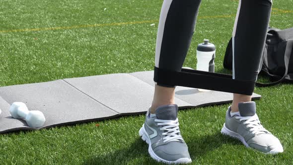 Woman Doing Workout Exercises with Elastic Rope Band