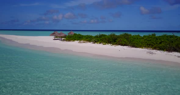 Beautiful overhead abstract view of a white sandy paradise beach and blue water background in 4K