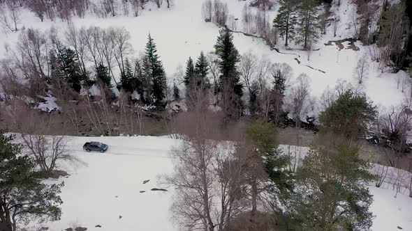View from Above of Driving a Car in a Winter Paradise in the Mountains of Karachay Cherkessia.
