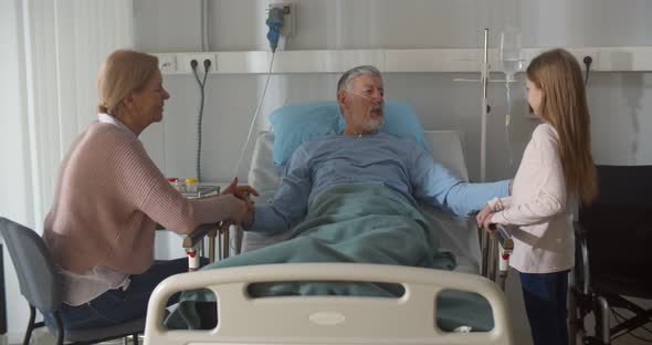 Little Girl Visiting Grandfather in Hospital with Mother