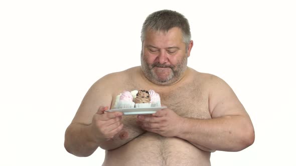 Fat Shirtless Man Holding Plate with Cakes