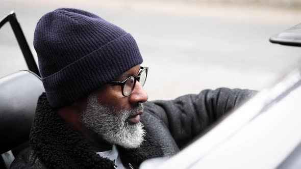 Man sitting in cabriolet waiting