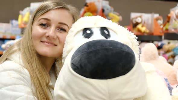 Beautiful Girl Received a Gift of a Soft Toy Dog