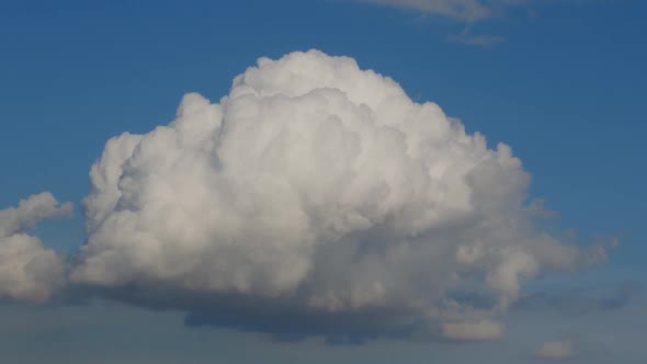 Moving Dramatic Single Cloud On A Blue Sky alt