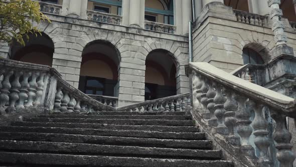 An Old Abandoned Marble Staircase with a Lift Up To the Mansion