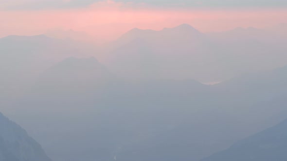 Beautiful clip of morning fog covering the mountain peaks of Schneibstein in Golling Austria