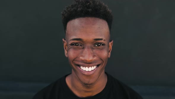 Happy young African teenager smiling in front of camera