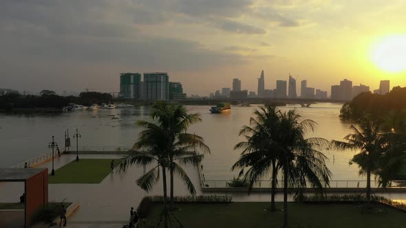 Beautiful tropical sunset park scene from drone with people enjoying leisure activities like skating