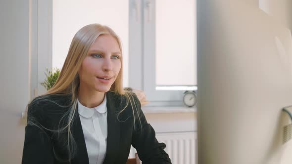 Upset Woman Sitting at Workplace. Blond Sad Female in Elegant Clothes Clutching Head After Failure