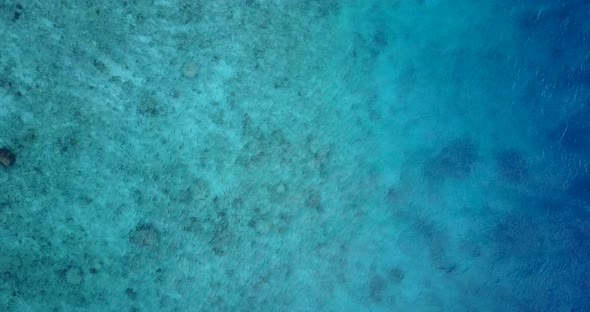 Tropical flying clean view of a white sand paradise beach and aqua blue water background in vibrant 