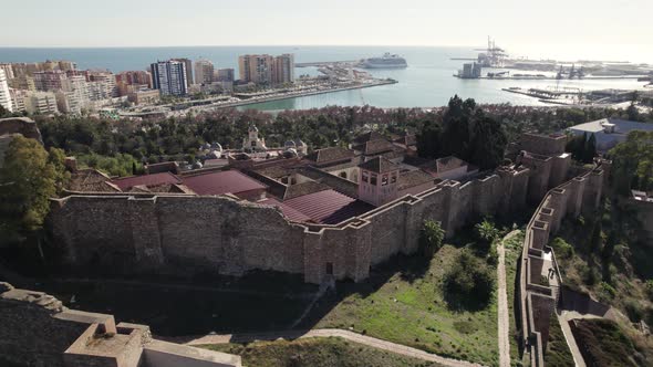 Aerial forward over Malaga Alcazaba with port in background, Spain