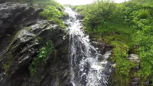 Waterfall in the mountains in slowmotion.