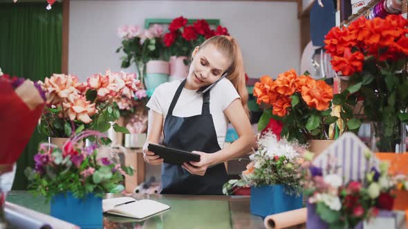 Sales Manager at Work Florist Female Discusses the Order By Talking on the Mobile Phone Using Screen