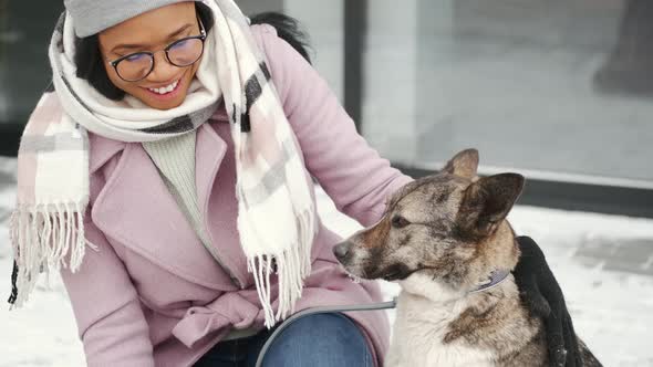 A Beautiful African American Woman Walking with Two Dogs