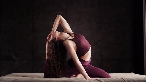 Girl Does Yoga on the Bed