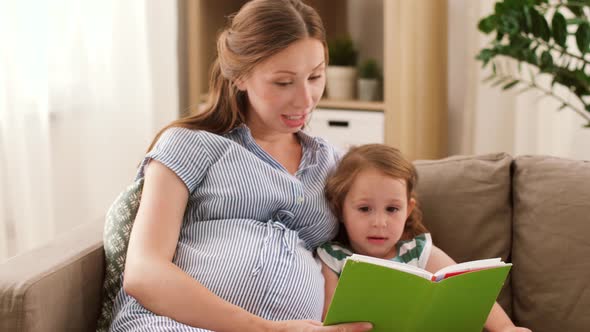 Pregnant Mother and Daughter Reading Book at Home 14