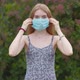 Beautiful young girl, blonde puts on a medical mask. - VideoHive Item for Sale