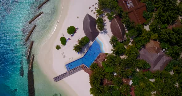 Wide overhead abstract shot of a sandy white paradise beach and blue water background in high resolu