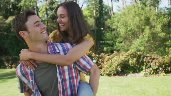 Portrait of happy caucasian couple in garden