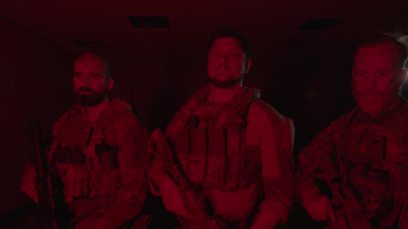 Soldiers in Bulletproof Vests Standing in Dark Room