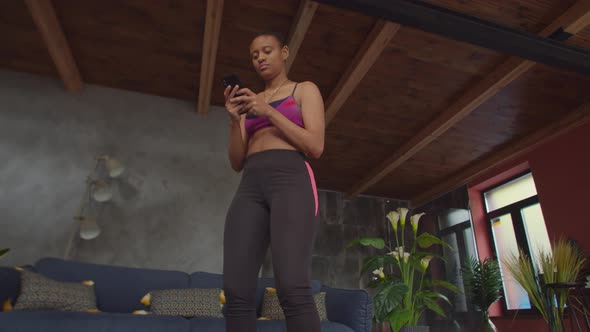 Female Online Messaging on Phone During Exercise