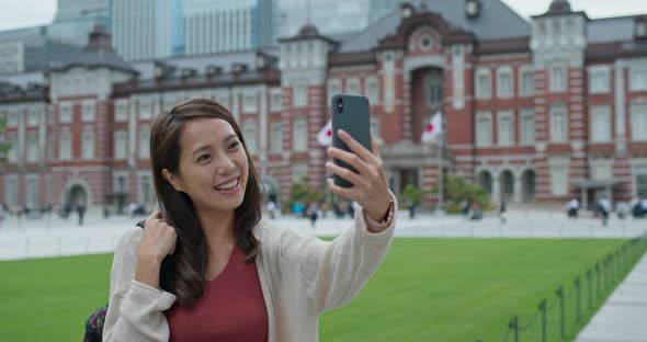Woman use of mobile phone for searching something at Tokyo station