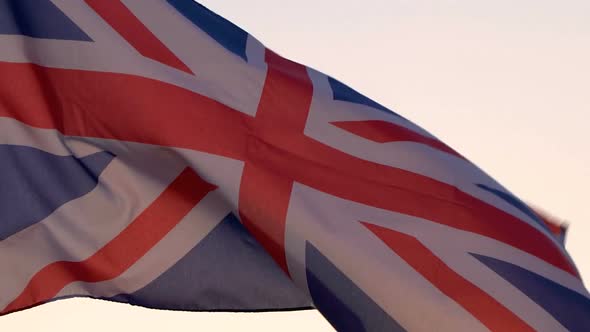 UK Flag Waving Over Sunset Sky alt