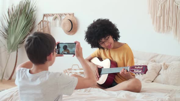 The Boy Films the Girl Who Plays the Guitar